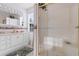 Compact bathroom featuring white vanity, shower-tub combo, decorative wall paper and tiled floor at 6593 Sunshine St. Nw, Ocean Isle Beach, NC 28469