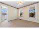Bright bedroom with two windows, neutral carpet, ceiling fan, and decorative wall paper border at 6593 Sunshine St. Nw, Ocean Isle Beach, NC 28469