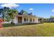Charming home featuring a stone facade chimney and a welcoming front porch with rocking chairs at 6593 Sunshine St. Nw, Ocean Isle Beach, NC 28469