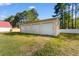 Detached garage with three doors, offering ample parking and storage, set against a green lawn at 6593 Sunshine St. Nw, Ocean Isle Beach, NC 28469