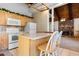 Bright kitchen with wooden cabinets, a cozy island, and an open view to the living room at 6593 Sunshine St. Nw, Ocean Isle Beach, NC 28469