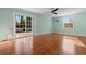 Spacious living room featuring wood floors, light blue walls, recessed lights, and sliding glass door to deck at 6593 Sunshine St. Nw, Ocean Isle Beach, NC 28469