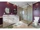 Elegantly designed main bathroom with double vanity, frameless shower, tiled floor, and custom paint at 6593 Sunshine St. Nw, Ocean Isle Beach, NC 28469