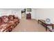 Comfortable living space with plush carpet, floral couch, and modern television at 6593 Sunshine St. Nw, Ocean Isle Beach, NC 28469