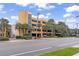 Exterior view of a modern parking garage with palm trees and manicured landscaping at 6900 North Ocean Blvd. # 938, Myrtle Beach, SC 29572