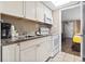 Cozy kitchen area with stainless steel sink, coffee maker, and a view into the bedroom at 6900 North Ocean Blvd. # 938, Myrtle Beach, SC 29572