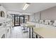 Bright laundry room with multiple washers, dryers, folding tables, and natural light at 6900 North Ocean Blvd. # 938, Myrtle Beach, SC 29572