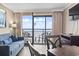 The living room features comfortable seating, modern furnishings and gorgeous ocean views from the balcony at 6900 North Ocean Blvd. # 938, Myrtle Beach, SC 29572