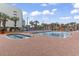 Inviting outdoor pool area with lounge chairs, a hot tub, and splash pad at 6900 North Ocean Blvd. # 938, Myrtle Beach, SC 29572