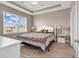 Bright bedroom featuring neutral walls, tray ceilings, and a large window at 701 Salleyport Dr. # 1117, Myrtle Beach, SC 29579