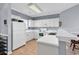 Eat-in kitchen with white appliances, countertop seating and tiled flooring at 701 Salleyport Dr. # 1117, Myrtle Beach, SC 29579
