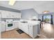 Bright kitchen with white appliances, adjacent to living area with hardwood flooring at 701 Salleyport Dr. # 1117, Myrtle Beach, SC 29579