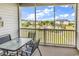 Screened porch featuring a table and seating with a view of the community and pool at 701 Salleyport Dr. # 1117, Myrtle Beach, SC 29579