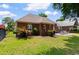 Well-maintained backyard with lawn, mature palms, privacy fence, and an outdoor dining area at 702 Compass Point Dr., North Myrtle Beach, SC 29582