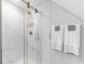Modern bathroom featuring a glass-enclosed shower with stylish fixtures and marble-look tile at 702 Compass Point Dr., North Myrtle Beach, SC 29582