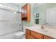 Bathroom featuring a bathtub with sliding glass doors, a toilet, and a vanity at 702 Compass Point Dr., North Myrtle Beach, SC 29582