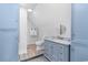 Bathroom featuring a toilet, vanity, and blue colored cabinets at 702 Compass Point Dr., North Myrtle Beach, SC 29582