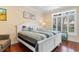 Comfortable bedroom with a queen-sized bed, window with blinds, and hardwood flooring at 702 Compass Point Dr., North Myrtle Beach, SC 29582