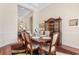 A formal dining area with wood table, seating for six, and beautiful wooden china cabinet at 702 Compass Point Dr., North Myrtle Beach, SC 29582