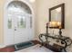 Elegant foyer with decorative glass door, complemented by stylish console table and accent mirror at 702 Compass Point Dr., North Myrtle Beach, SC 29582