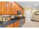 Well-lit kitchen featuring granite countertops, stainless steel appliances, and ample cabinet storage space at 702 Compass Point Dr., North Myrtle Beach, SC 29582