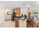 Well-equipped kitchen with stainless steel appliances, granite countertops, and ample cabinet space, adjacent to a living area at 702 Compass Point Dr., North Myrtle Beach, SC 29582