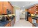 Kitchen with stainless appliances, tile floors, and ample cabinet space, flowing into the dining and living areas at 702 Compass Point Dr., North Myrtle Beach, SC 29582