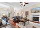 Spacious living room with fireplace, wood floors, and comfortable seating area at 702 Compass Point Dr., North Myrtle Beach, SC 29582