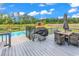 View from back porch featuring a grill and dining table with views of the pool and garden at 7377 Pauley Swamp Rd., Conway, SC 29527