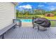 Outdoor back porch with grill and view of backyard pool and landscaping at 7377 Pauley Swamp Rd., Conway, SC 29527