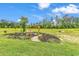 Backyard view showcasing the garden with an arbor, seating, and open green space at 7377 Pauley Swamp Rd., Conway, SC 29527