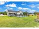 View of home's backyard featuring an in-ground pool with black metal safety fence and covered porch at 7377 Pauley Swamp Rd., Conway, SC 29527
