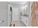 Bright bathroom featuring double vanity, walk-in shower, and tile floors at 7377 Pauley Swamp Rd., Conway, SC 29527