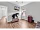 Bright bedroom featuring neutral paint, hardwood floors, and mounted TV at 7377 Pauley Swamp Rd., Conway, SC 29527