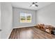 Bright bedroom with a large window, hardwood floors, and neutral wall color at 7377 Pauley Swamp Rd., Conway, SC 29527