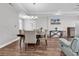 Dining space showcasing hardwood floors, modern lighting, and a seamless flow to the living space at 7377 Pauley Swamp Rd., Conway, SC 29527