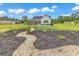 View of home's landscaping featuring a rock and mulch garden, as well as a black metal pool fence at 7377 Pauley Swamp Rd., Conway, SC 29527
