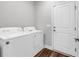 Bright laundry room featuring a white washer and dryer plus exterior access at 7377 Pauley Swamp Rd., Conway, SC 29527