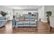 Open-concept living area featuring hardwood floors, a comfortable couch, and a view into the kitchen at 7377 Pauley Swamp Rd., Conway, SC 29527