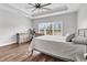 Bright main bedroom featuring tray ceilings, wood-look floors, and large windows with a view of the outdoors at 7377 Pauley Swamp Rd., Conway, SC 29527