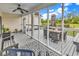 Screened in back porch features a ceiling fan, dining table and sitting area at 7377 Pauley Swamp Rd., Conway, SC 29527