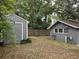View of backyard with detached garage, wood fence and mature trees at 7708 Woodland Dr., Myrtle Beach, SC 29572