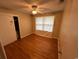 Bedroom with hardwood floors and a closet; needs TLC at 7708 Woodland Dr., Myrtle Beach, SC 29572