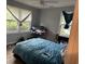 Bedroom with carpeted floors, two windows, and a closet; needs TLC at 7708 Woodland Dr., Myrtle Beach, SC 29572
