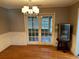 Formal dining room with hardwood floors, chandelier, and sliding door access to outdoors at 7708 Woodland Dr., Myrtle Beach, SC 29572