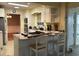 Bright eat-in kitchen featuring white cabinets, a breakfast bar, and an open layout to the dining room at 7708 Woodland Dr., Myrtle Beach, SC 29572