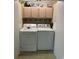 Functional laundry room featuring a washer and dryer with storage cabinets above at 7708 Woodland Dr., Myrtle Beach, SC 29572