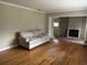 Spacious living room featuring hardwood floors and a doorway to the fireplace and additional room at 7708 Woodland Dr., Myrtle Beach, SC 29572