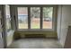 Sunroom with windows overlooking the backyard; needs TLC at 7708 Woodland Dr., Myrtle Beach, SC 29572