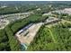 Expansive aerial view of a Primary-planned community, showcasing homes nestled among lush greenery, ponds, and roadways at 776 Nw Palm Frond Way # 55, Calabash, NC 28467